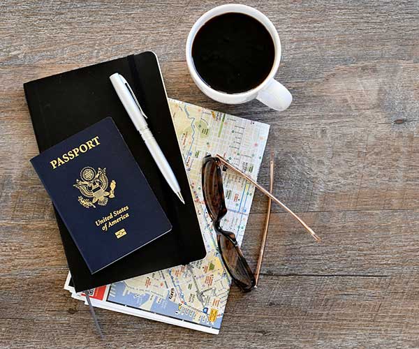 US passport and coffee on table